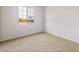 Bright, carpeted bedroom featuring a large window with picturesque views at 27110 W Adam Ave, Buckeye, AZ 85396