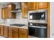 A modern kitchen with stainless steel appliances and wood cabinets at 27110 W Adam Ave, Buckeye, AZ 85396