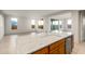 Kitchen island with sink and granite countertops overlooking the living area at 27110 W Adam Ave, Buckeye, AZ 85396