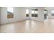 Bright living room offering tile floors, neutral paint, and multiple large windows at 27110 W Adam Ave, Buckeye, AZ 85396