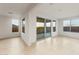 Bright open-concept living area with large windows and sliding glass door at 27110 W Adam Ave, Buckeye, AZ 85396