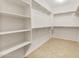 Spacious walk-in closet with shelving and ample storage space, perfect for organizing your wardrobe at 27110 W Adam Ave, Buckeye, AZ 85396