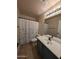 Neutral bathroom featuring a shower and tub combination, with a black faucet at 2729 E Carol Ave, Mesa, AZ 85204