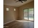 An empty bedroom with a sliding glass door featuring a pool view at 2729 E Carol Ave, Mesa, AZ 85204