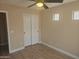 A bedroom featuring a ceiling fan, wood-style flooring, and a closet with white sliding doors at 2729 E Carol Ave, Mesa, AZ 85204