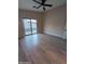 Spacious bedroom with wood floors and a sliding glass door to the pool area at 2729 E Carol Ave, Mesa, AZ 85204