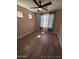 This room is brightly lit with hardwood floors, fan and natural light at 2729 E Carol Ave, Mesa, AZ 85204