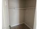 A walk-in closet with wooden floors and a rod for hanging clothing at 2729 E Carol Ave, Mesa, AZ 85204