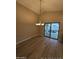 Bright dining area featuring wood-look floors, slider access to the patio, and modern lighting fixture at 2729 E Carol Ave, Mesa, AZ 85204