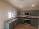 Kitchen featuring dark countertops and appliances, and ample cabinet space at 2729 E Carol Ave, Mesa, AZ 85204