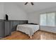 Bright bedroom showcasing a minimalist design, complemented by a large window and hardwood floors at 2834 S Extension Rd # 1079, Mesa, AZ 85210