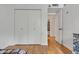 Bedroom with hard wood floors, a closet, and a bathroom behind an open door at 2834 S Extension Rd # 1079, Mesa, AZ 85210