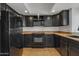 Modern kitchen featuring black appliances, dark cabinets, and granite countertops at 2834 S Extension Rd # 1079, Mesa, AZ 85210