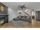 Bright living room with a fireplace, ceiling fan, and open staircase to the second floor at 2834 S Extension Rd # 1079, Mesa, AZ 85210