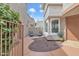 Private patio area with seating, surrounded by mature plants and desert landscaping at 2834 S Extension Rd # 1079, Mesa, AZ 85210