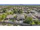 Aerial view showing a home with a pool, patio, putting green, and solar panels in a residential community at 3662 E Megan St, Gilbert, AZ 85295