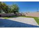 Spacious backyard featuring a large tile patio area and artificial turf, perfect for outdoor entertaining at 3662 E Megan St, Gilbert, AZ 85295