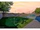 Picturesque backyard featuring a putting green, artificial turf, seating area, and ambient string lights at 3662 E Megan St, Gilbert, AZ 85295