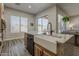 Bright kitchen features a large island with a farmhouse sink, granite countertops, and modern appliances at 3662 E Megan St, Gilbert, AZ 85295