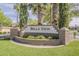 Bella Vista stone entrance sign with palm trees and manicured greenery providing a welcoming view at 3662 E Megan St, Gilbert, AZ 85295