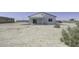 View of the back of the house showing the patio and landscaped yard, with a truck parked nearby at 3725 N Bandelier Dr, Eloy, AZ 85131