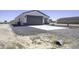 Single-story home featuring a gray two-car garage, concrete driveway, and desert landscaping at 3725 N Bandelier Dr, Eloy, AZ 85131