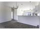 An open kitchen featuring stainless steel appliances, bar seating, and wood look tile is bright and airy at 3725 N Bandelier Dr, Eloy, AZ 85131