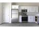 Modern kitchen with white cabinets, stainless steel appliances, and stylish tile flooring at 3725 N Bandelier Dr, Eloy, AZ 85131