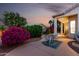 Landscaped backyard with a patio set among lush flowering bushes, perfect for enjoying the outdoors at 3781 N 161St Dr, Goodyear, AZ 85395