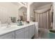 Well-lit bathroom offering dual sinks and a shower, providing comfort and functionality at 3781 N 161St Dr, Goodyear, AZ 85395