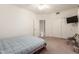 Neutral bedroom has a ceiling fan, closet with sliding doors, and adjacent bathroom entrance at 3781 N 161St Dr, Goodyear, AZ 85395