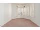 Light-filled bedroom with neutral carpet, window shutters, and decorator treatments at 3781 N 161St Dr, Goodyear, AZ 85395