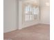 Bright bedroom with neutral carpet and decorator touches on the shuttered windows at 3781 N 161St Dr, Goodyear, AZ 85395