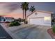 A single-story house featuring a concrete driveway and desert landscaping at 3781 N 161St Dr, Goodyear, AZ 85395