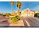Single-story home featuring desert landscaping, palm trees and a two-car garage at 3781 N 161St Dr, Goodyear, AZ 85395