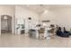 Spacious kitchen offers ample storage, bar seating, tile floors, and open access to the living area at 3781 N 161St Dr, Goodyear, AZ 85395