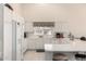 Bright kitchen features white cabinets, tiled floors, modern appliances, and ample counter space at 3781 N 161St Dr, Goodyear, AZ 85395