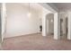 Expansive living room featuring neutral carpet, archways, and decorative chandelier at 3781 N 161St Dr, Goodyear, AZ 85395