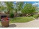 Lush backyard featuring a well-maintained lawn, mature trees, and beautiful landscaping, perfect for outdoor enjoyment at 3945 E Cherry Hills Dr, Chandler, AZ 85249