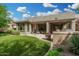 Expansive backyard with a manicured lawn, covered patio, and outdoor kitchen, ideal for relaxation and entertainment at 3945 E Cherry Hills Dr, Chandler, AZ 85249