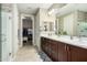 Bathroom featuring double vanity sinks, a separate shower, and access to a walk-in closet at 3945 E Cherry Hills Dr, Chandler, AZ 85249