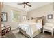 Cozy bedroom with a comfortable bed, stylish decor, and a ceiling fan for enhanced air circulation at 3945 E Cherry Hills Dr, Chandler, AZ 85249