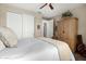 Well-lit bedroom featuring a closet, wooden armoire and contemporary decor creating a comfortable and stylish space at 3945 E Cherry Hills Dr, Chandler, AZ 85249