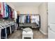 Spacious walk-in closet with ample hanging space, shoe racks, and a central ottoman, maximizing organization at 3945 E Cherry Hills Dr, Chandler, AZ 85249