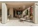 Inviting covered patio with brick pavers, ceiling fan, lounge chair, and dining set for outdoor relaxation and entertaining at 3945 E Cherry Hills Dr, Chandler, AZ 85249