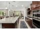Bright kitchen features pendant lighting, a large island, modern appliances, and views of the outdoor space at 3945 E Cherry Hills Dr, Chandler, AZ 85249