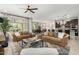 Open-concept living space featuring comfortable leather couches, natural light, and modern kitchen at 3945 E Cherry Hills Dr, Chandler, AZ 85249