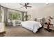 Serene main bedroom with a ceiling fan, large window, and cozy seating area with natural light at 3945 E Cherry Hills Dr, Chandler, AZ 85249