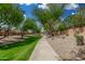 Scenic walking path lined with mature trees and lush landscaping, providing a peaceful and picturesque environment at 3945 E Cherry Hills Dr, Chandler, AZ 85249