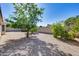 The spacious backyard is xeriscaped with mature citrus trees and a privacy wall at 4001 E Rosemonte Dr, Phoenix, AZ 85050